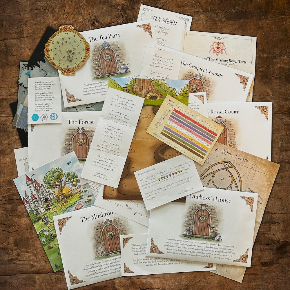 Down The Rabbit Hole game materials on a wooden table: Wonderland illustrations, handwritten letters, a green cipher wheel and a printed Tea Party page