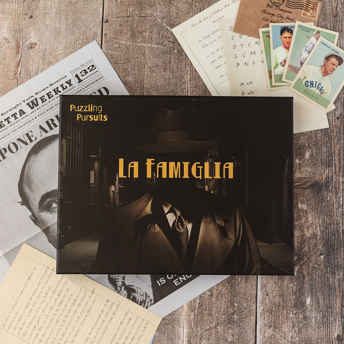 The La Famiglia game box on a wooden table, a 1929 Chicago mafia mystery in a single box