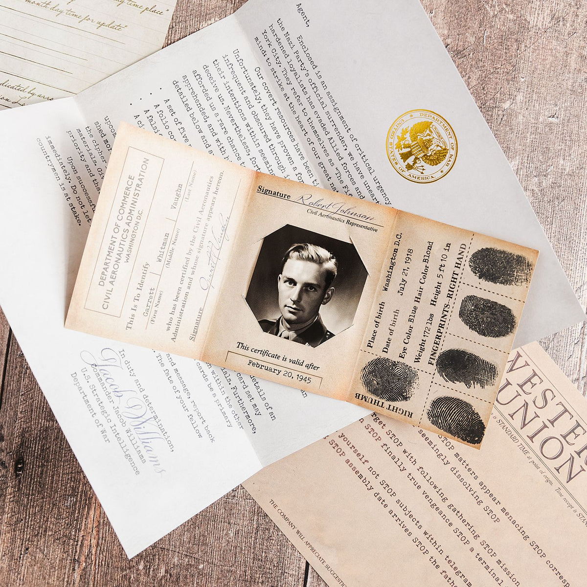 A pair of hands working through printed mystery game documents at a table, the scale of puzzle two players can share