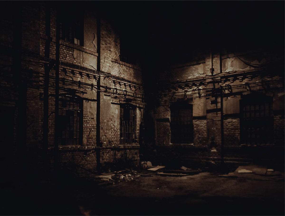 The Takedown: a dark warehouse courtyard at night