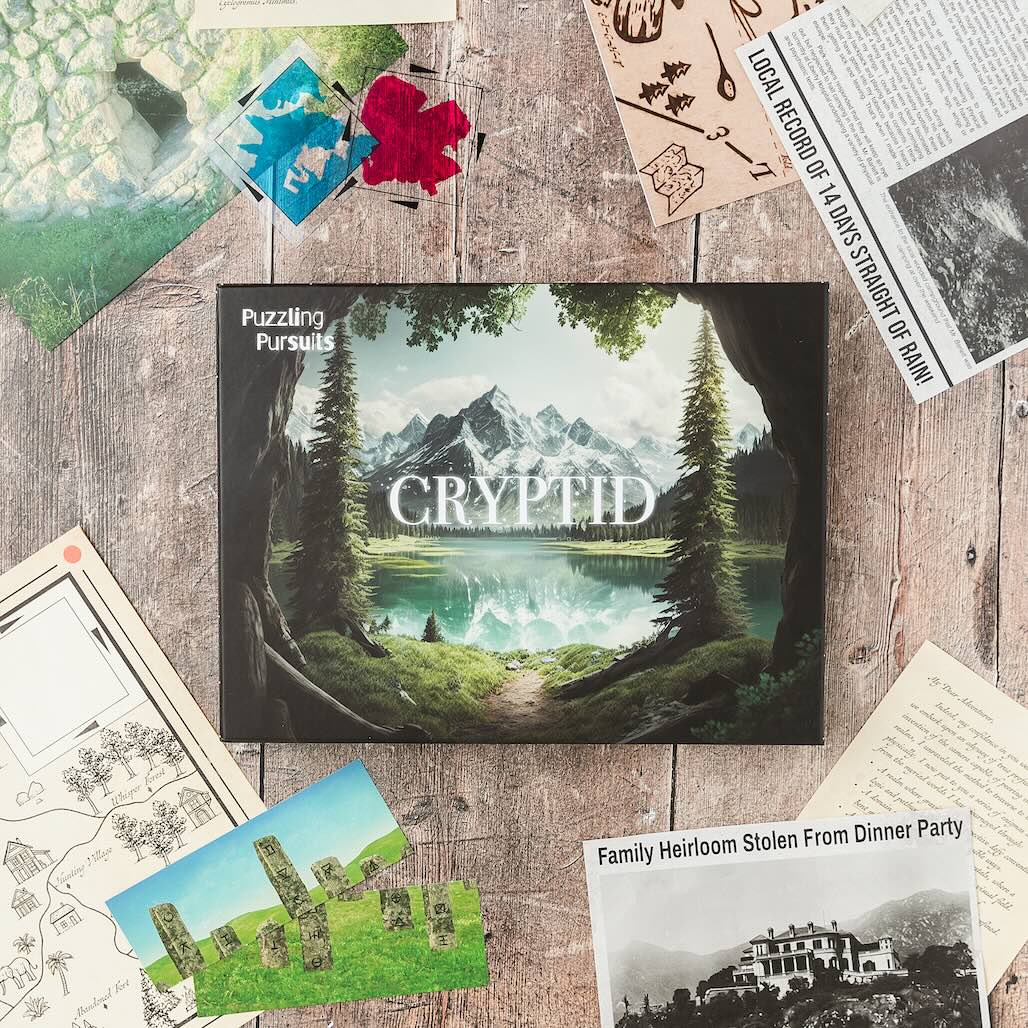 The Cryptid game box standing on a desk, its cover showing a misty forest lake framed by pine trees and mountains
